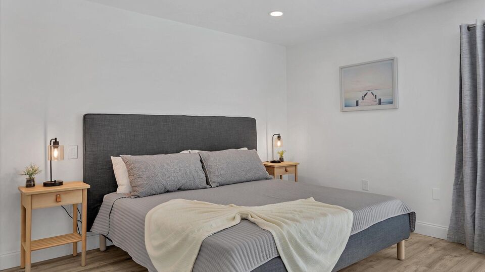 Primary bedroom with king bed, attached bathroom, access to backyard