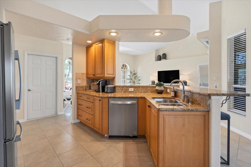 Fully-equipped kitchen over looking the living room and dining area