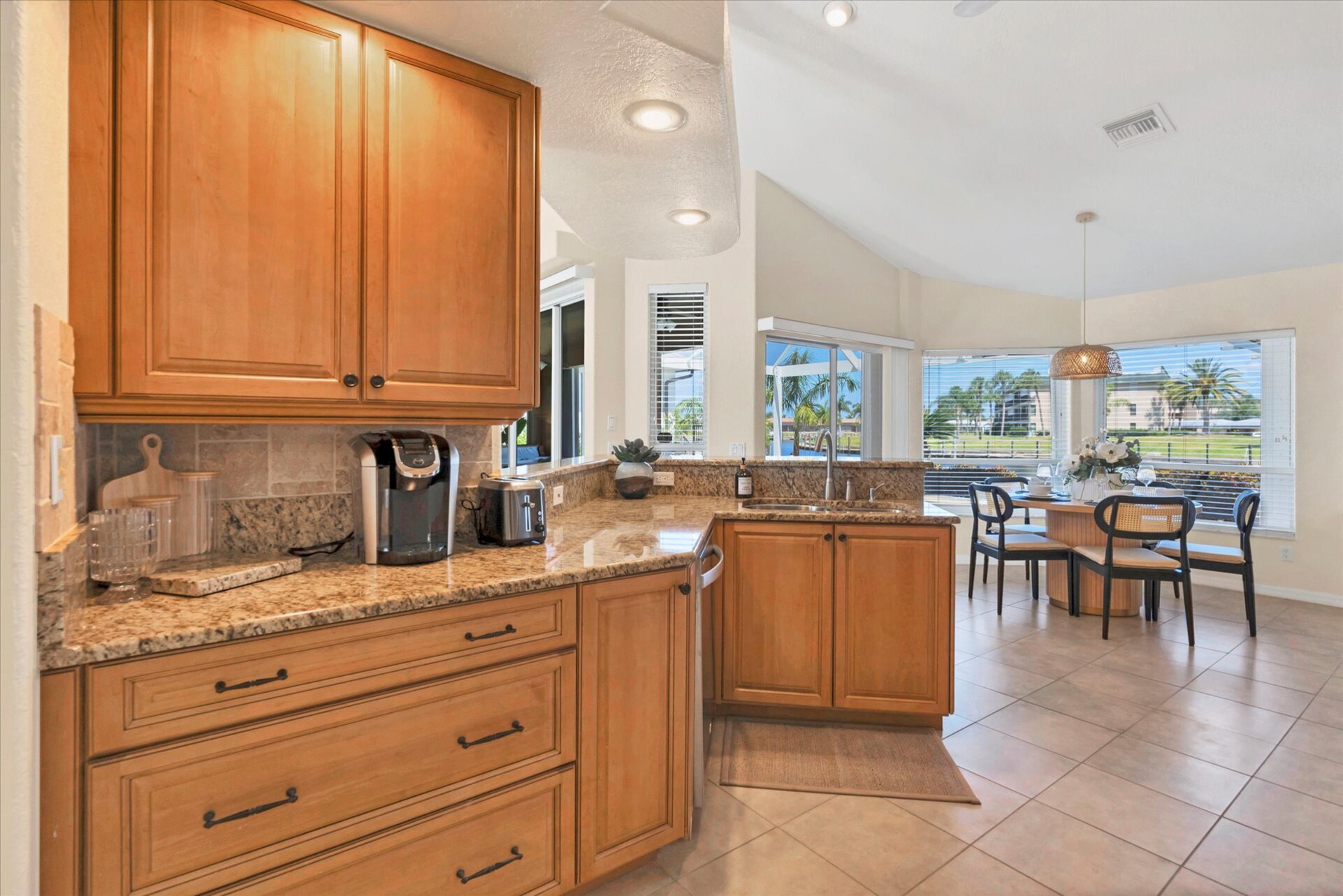 Fully-equipped kitchen over looking the living room and dining area