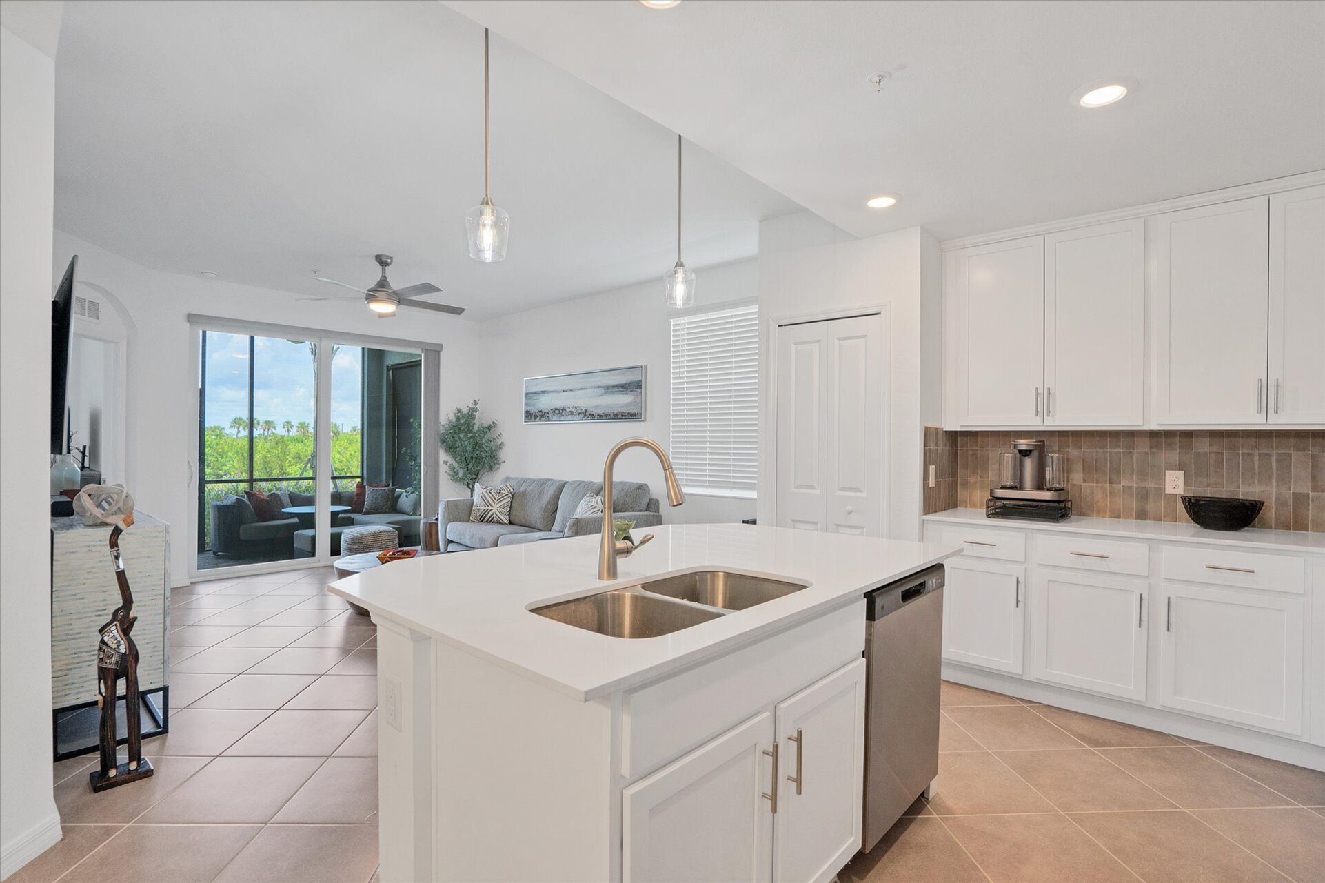 Bright, fully-equipped kitchen overlooking dining room & living room. Kitchen island seats 2