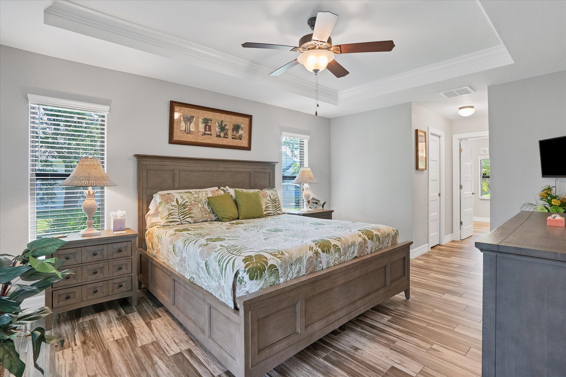Primary bedroom with lanai access, attached bathroom and 32-inch Smart TV