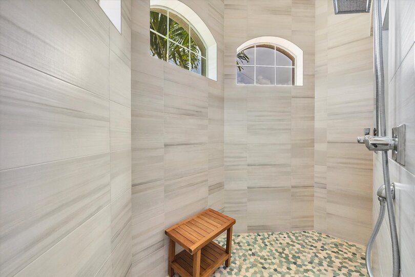 Beautiful primary en suite with large walk-in shower and double vanities