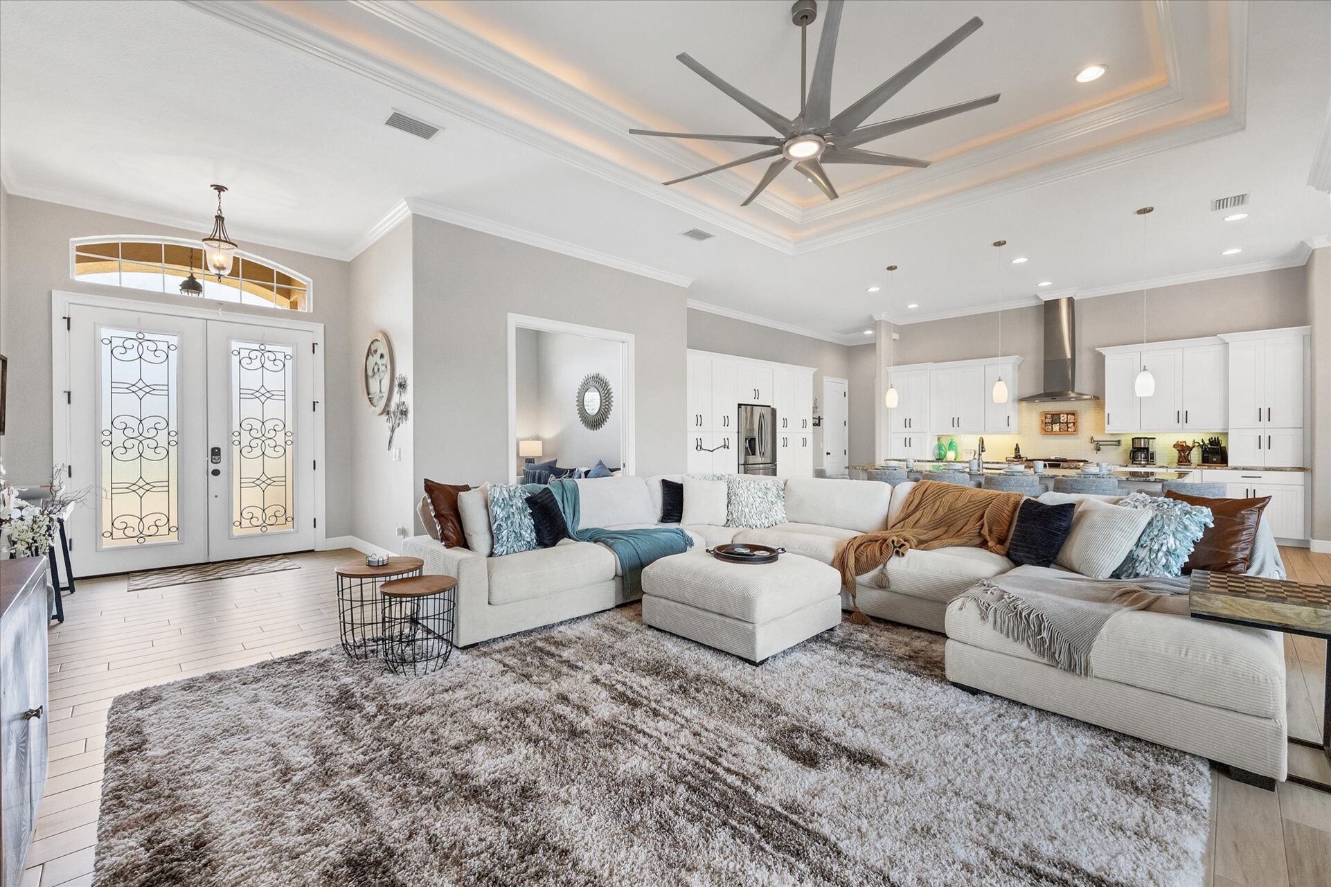 Gorgeous, open living space overlooking private pool, canal, and nature preserve beyond. Living room features lots of comfy seating and 70-inch Smart TV