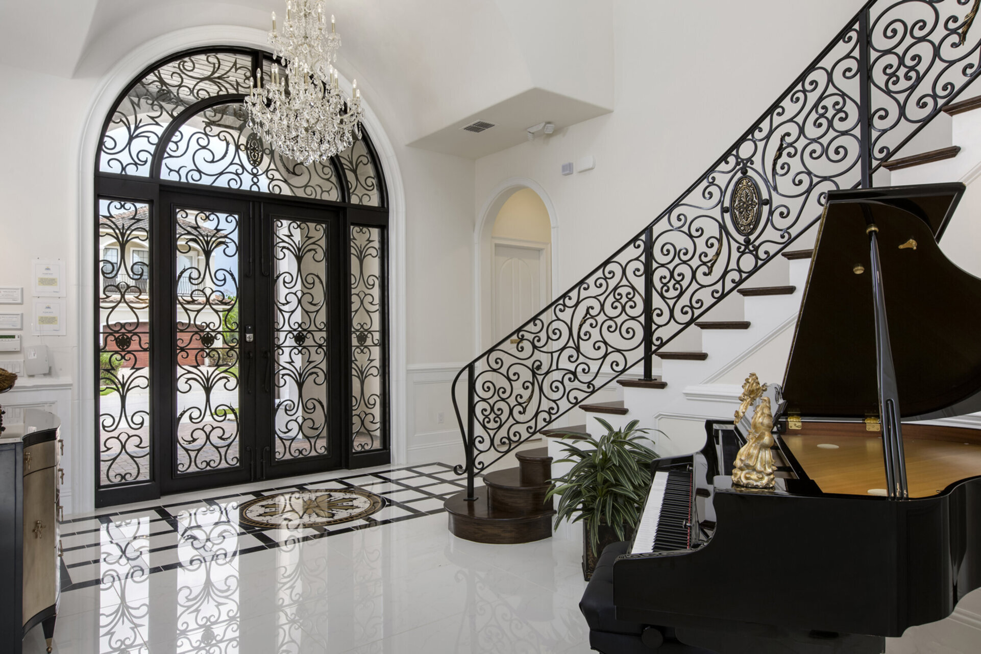 Be wowed by the foyer with a sweeping staircase and grand piano with an 8,000 song library