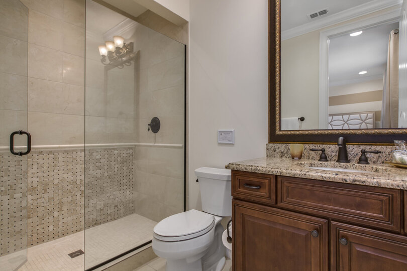 The en-suite bathroom has a walk-in shower
