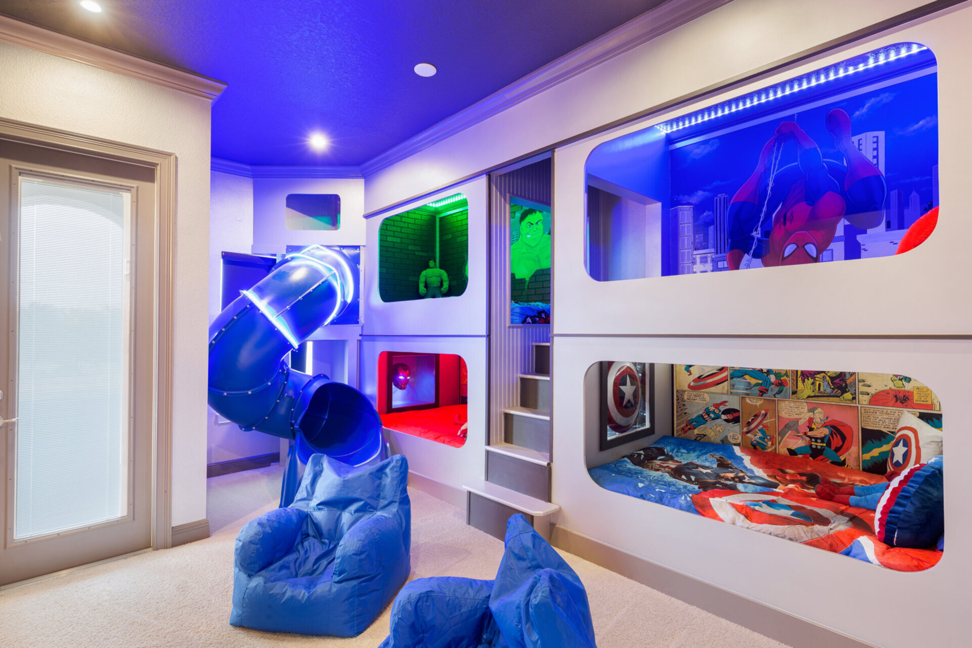 The kids will love this bedroom with custom built beds featuring a fun slide