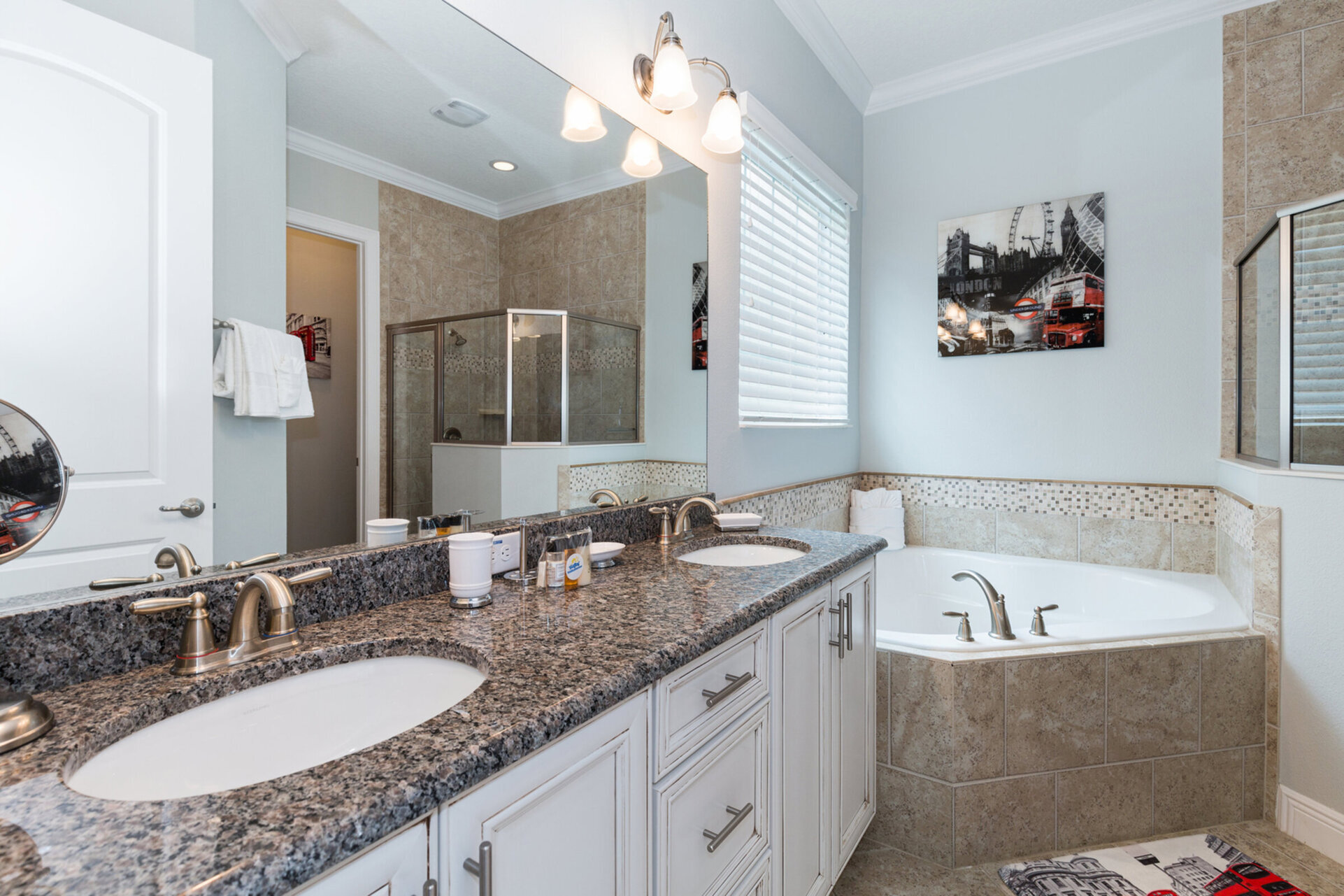 Master bathroom on the ground floor with dual vanity, garden tub, and walk-in shower
