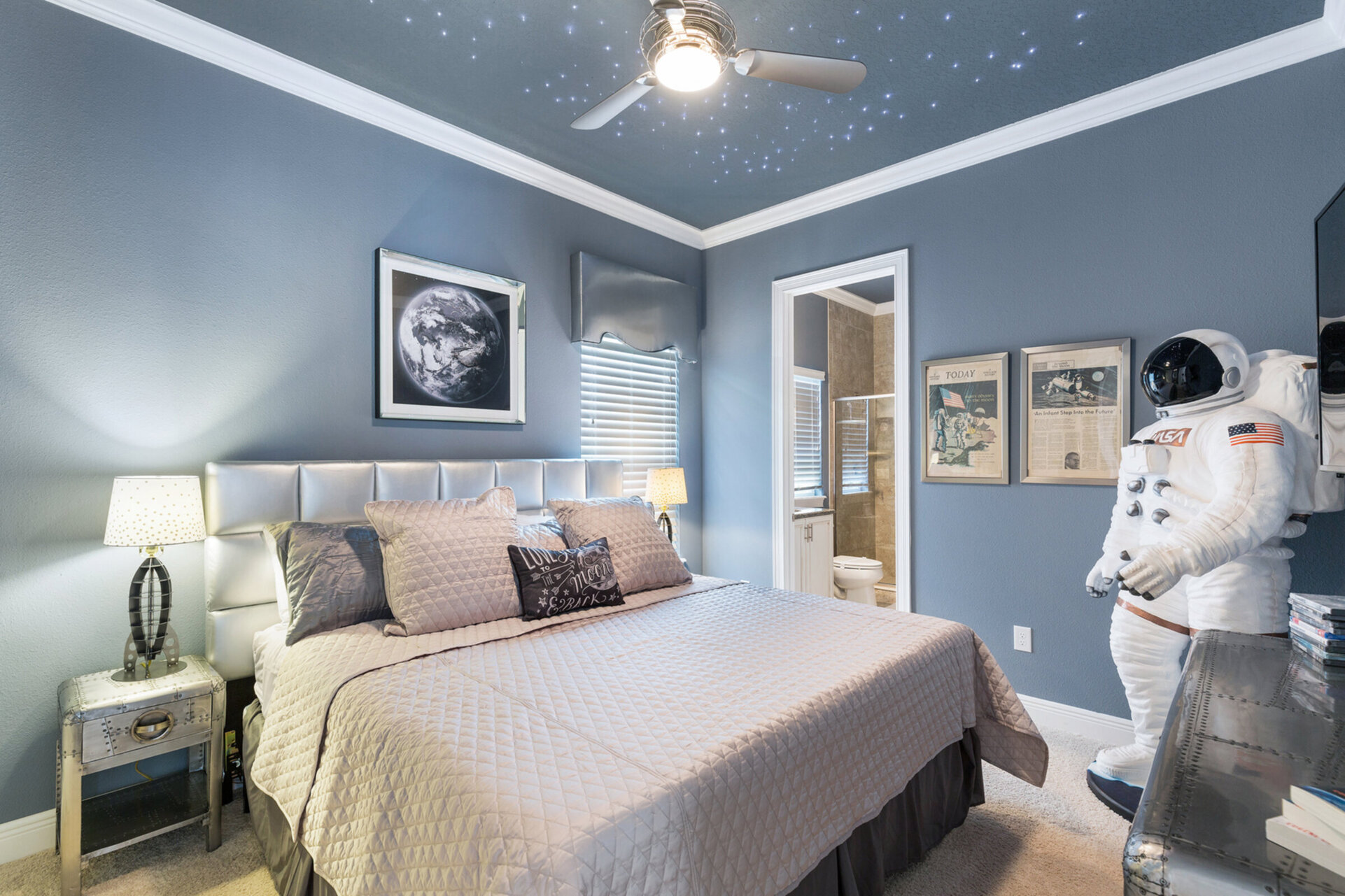 This out of this world bedroom is perfectly decorated with star lights built into the ceiling and a life size Astronaut