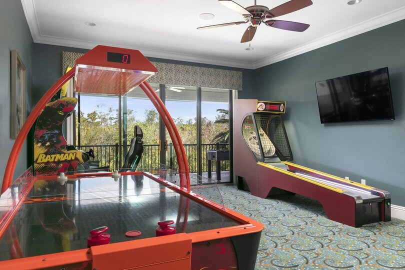 Second floor games room features a Batman Racing Arcade, Skee-Ball, and Air hockey table