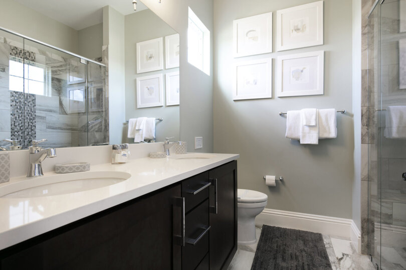 The en-suite bathroom has a glass door walk-in shower and dual vanity