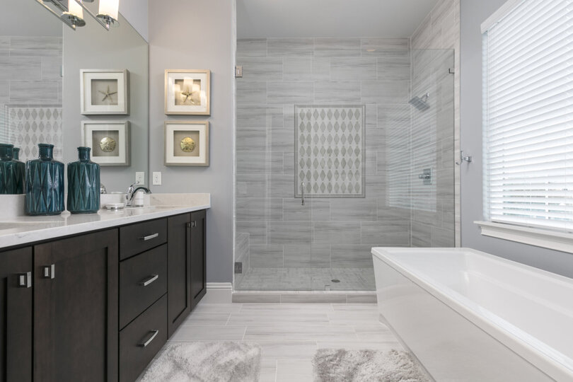 The en-suite bathroom features glass door walk-in shower and garden tub