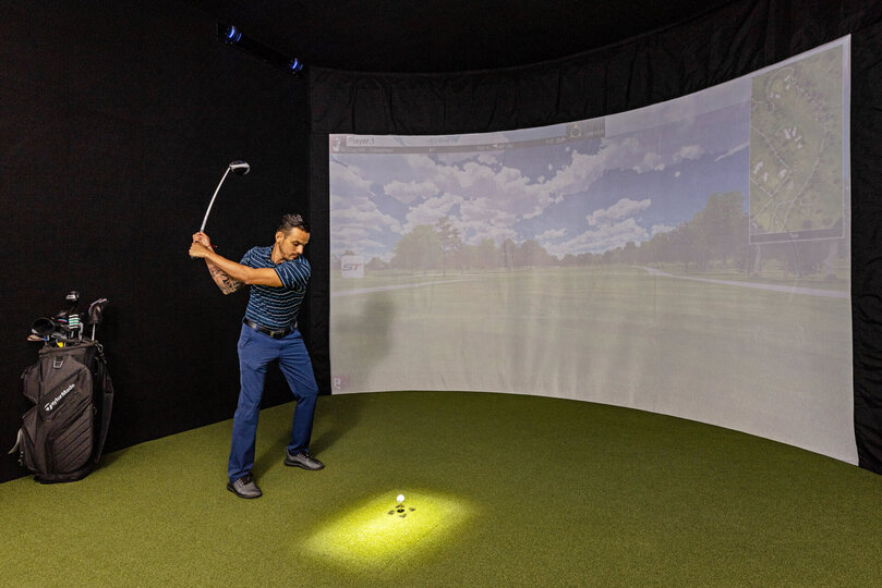 This High-Tech Sports Simulator Room features a SwingTrack Elite simulator with 87 PGA Golf Courses and 13 Sports Games