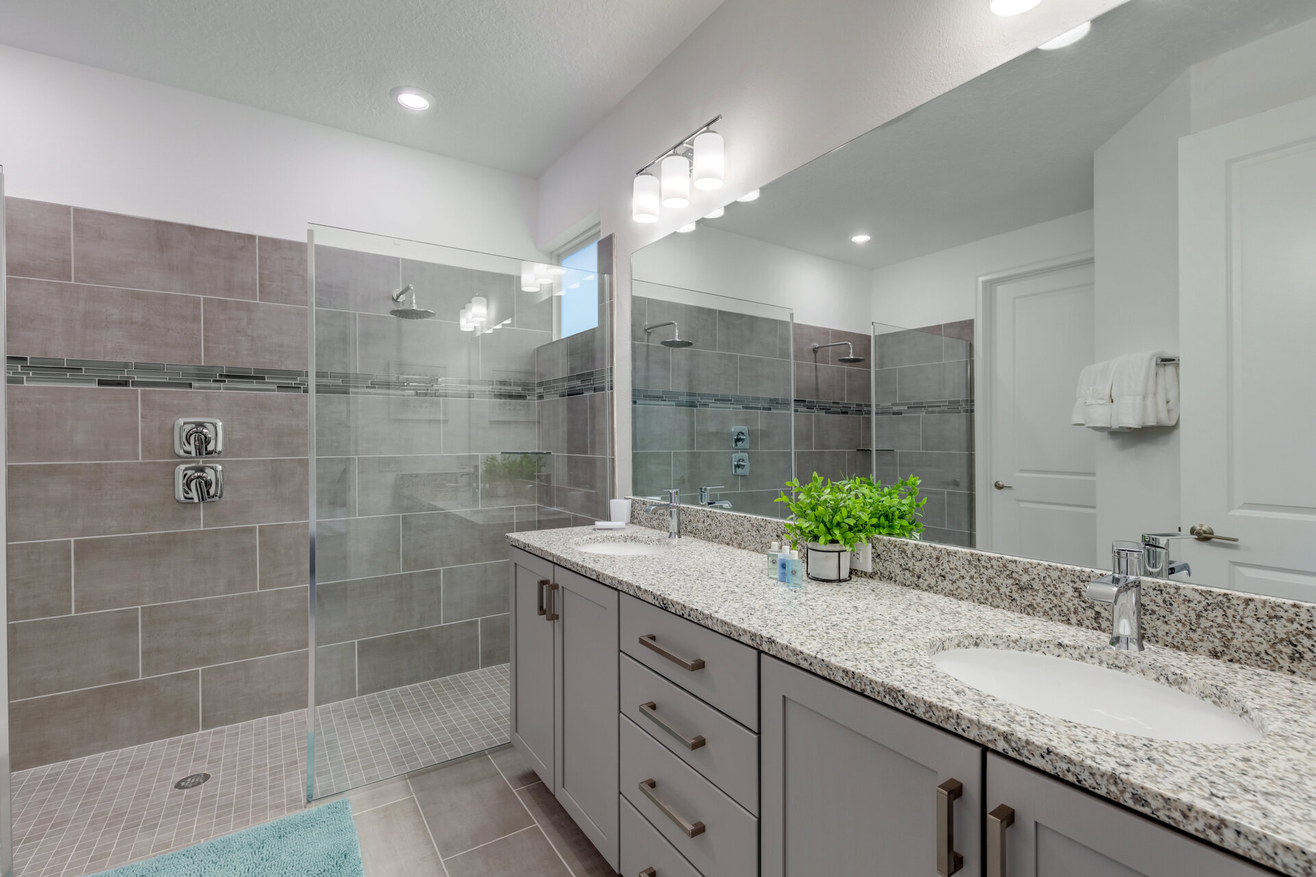Ensuite bath with a large vanity and beautiful walk in shower