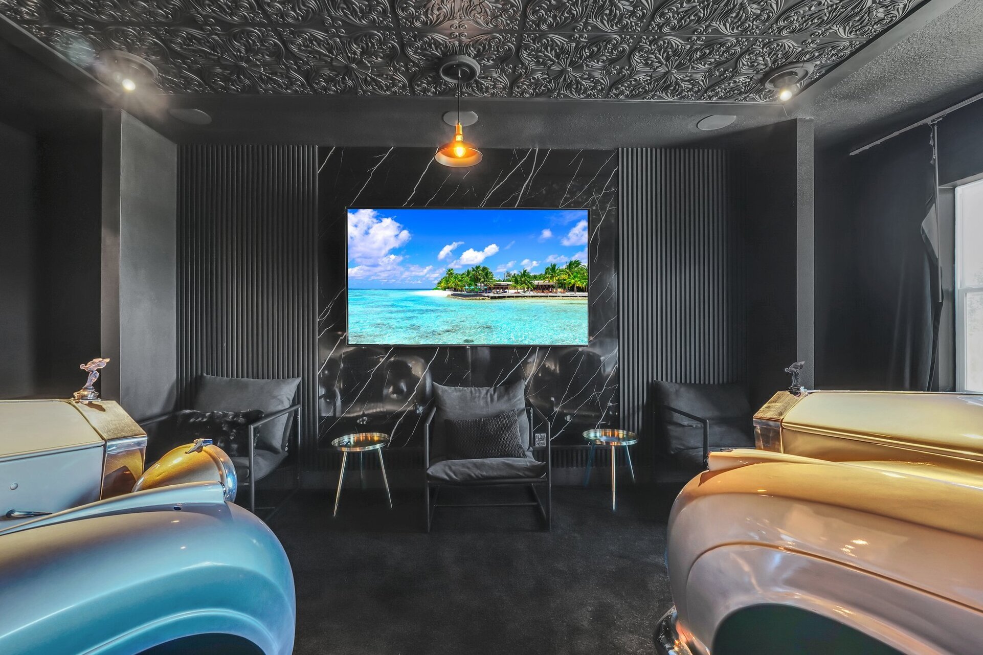 The movie room features a large screen and high-end sound system for a true cinematic experience