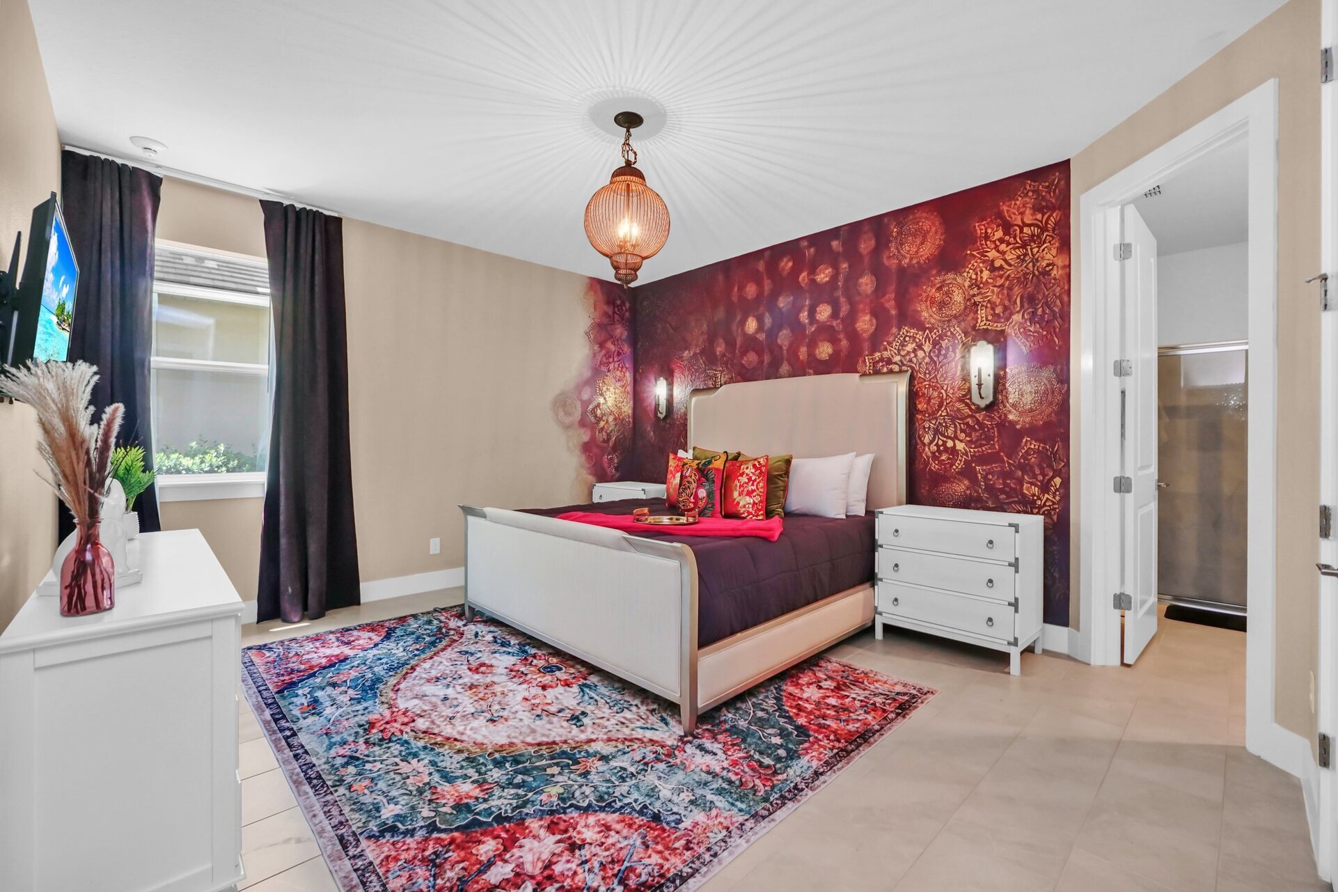 Escape to the vibrant master bedroom, a spacious retreat adorned with colorful decor and comfortable furnishings