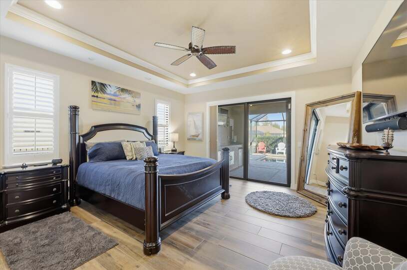 Primary bedroom with king bed, en suite, lanai accress, and 65-inch Smart TV