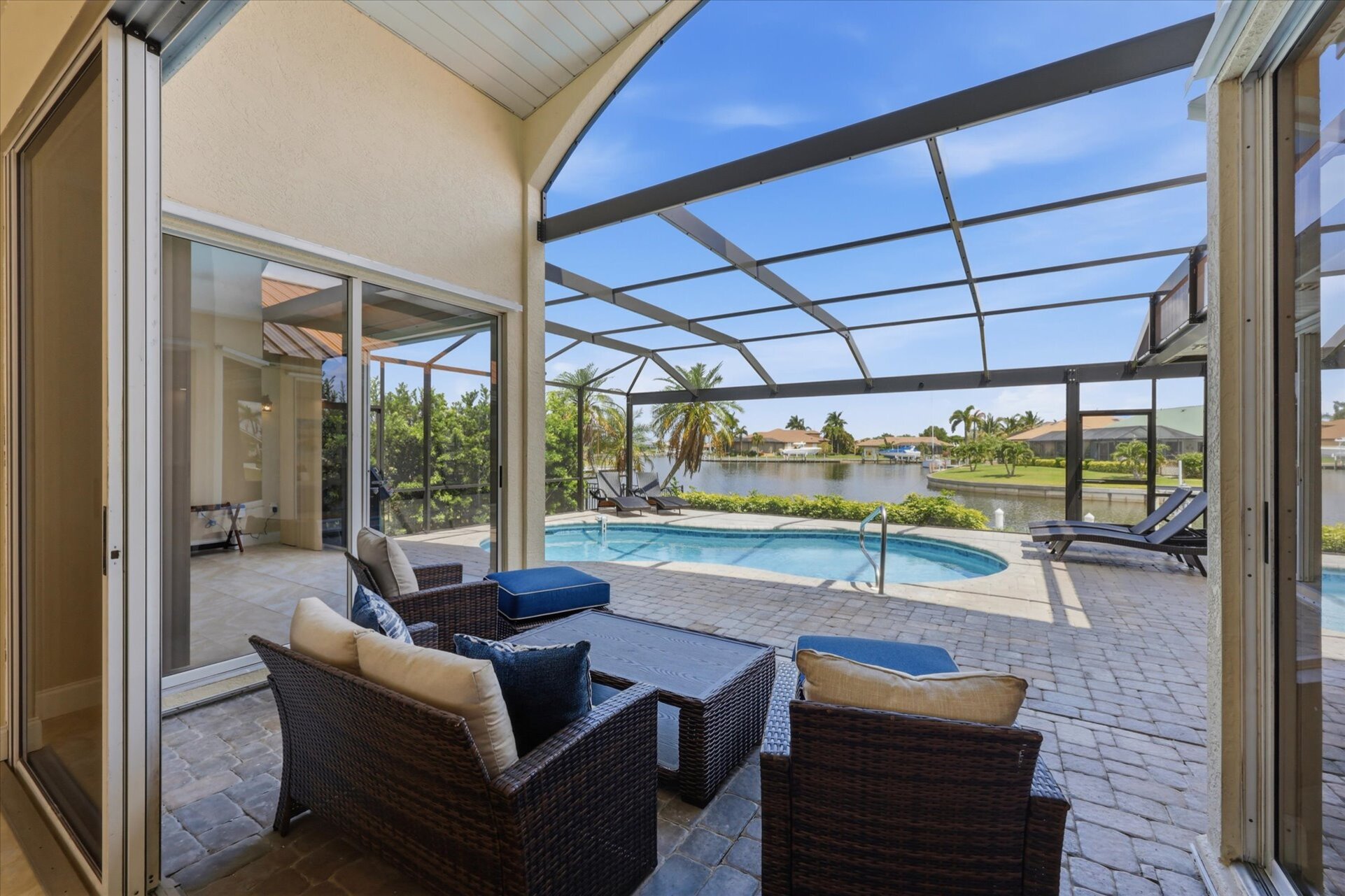 Great outdoor living space overlooking the canal. Features a sparkling pool, sun loungers, and BBQ grill. Pool size: 25' x 13' x 6'D