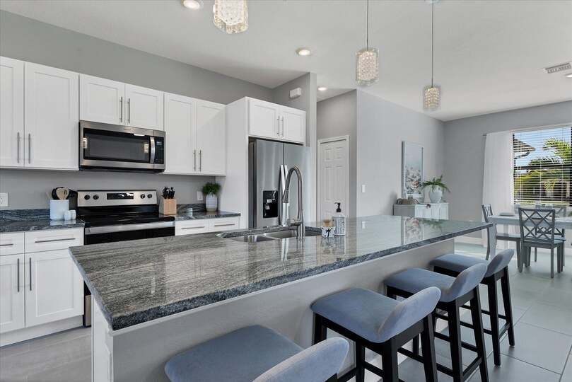 Fully equipped kitchen overlooking living room and dining area
