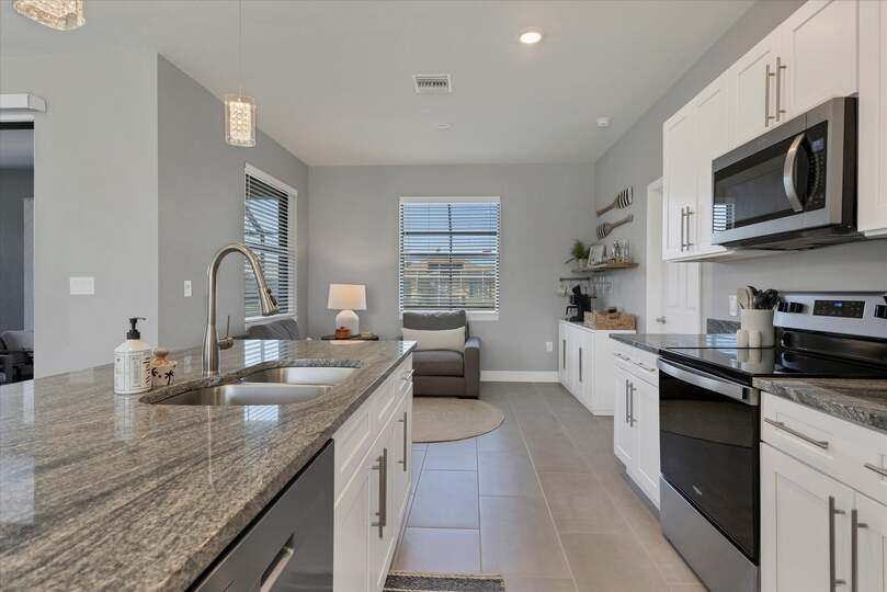 Fully equipped kitchen overlooking living room and dining area