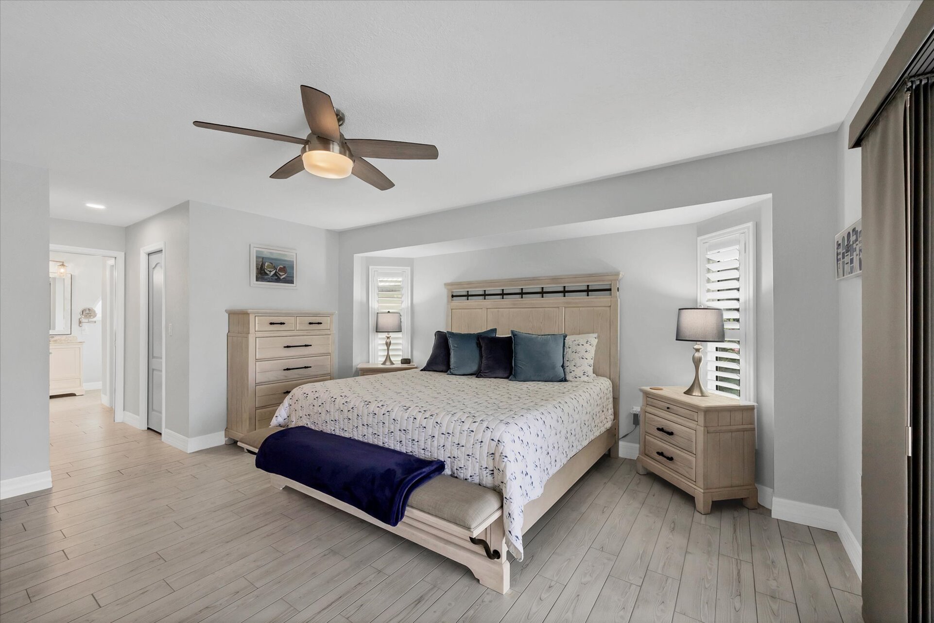 Primary bedroom with King bed, Lanai Access, en suite, and 42" Smart TV
