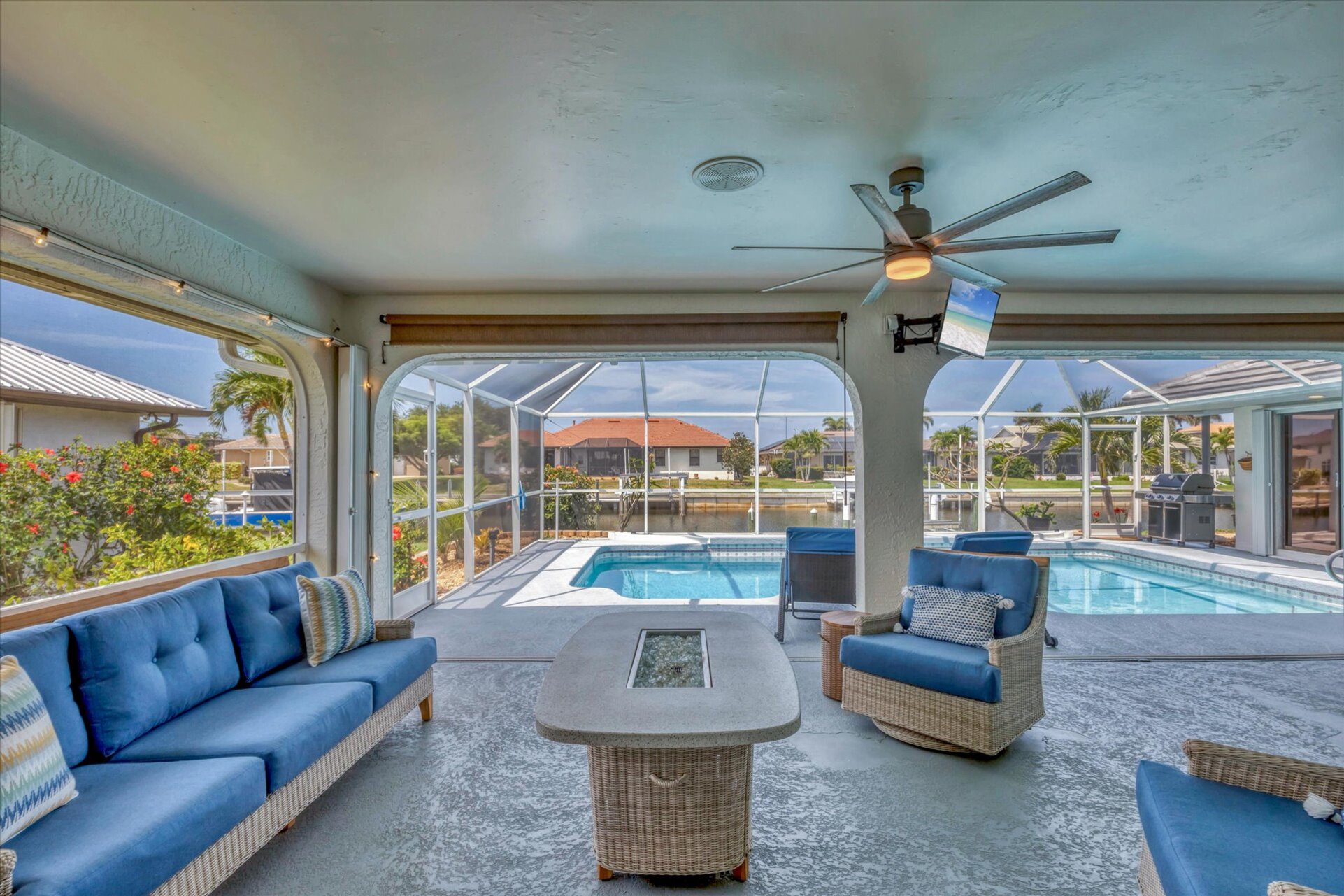 The Best of Florida Outdoor Living. Screened In Lanai overlooking the sparkling private pool and canal with 32" TV