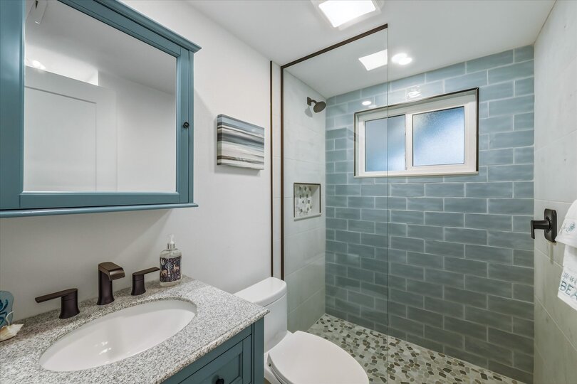 Bedroom 1's attached bathroom with walk-in shower and double vanities