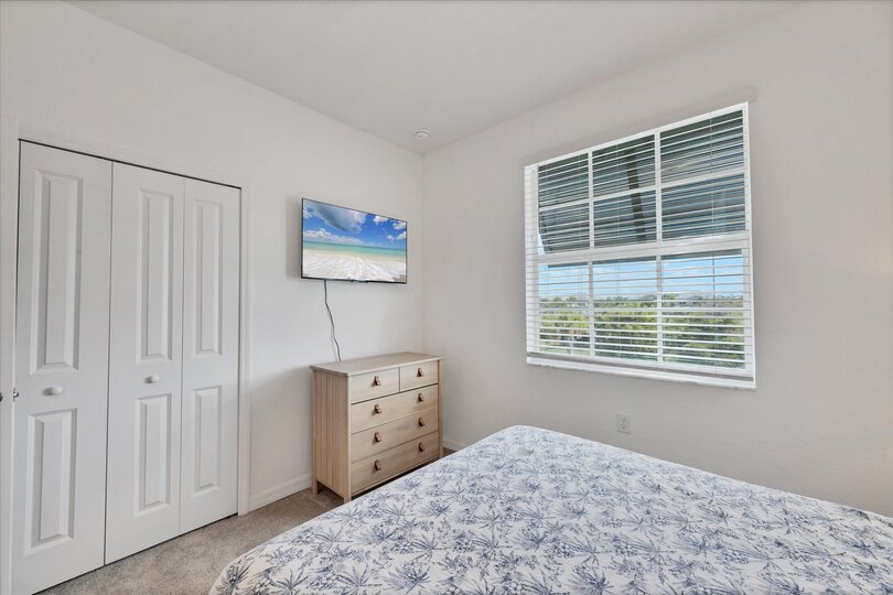 Guest bedroom 2 with one queen bed and 43-inch Smart TV