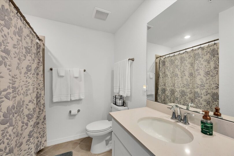 Primary attached bathroom with walk-in shower and double vanities