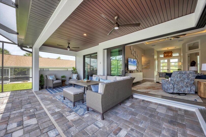 Fantastic outdoor living space overlooking the sparkling pool and canal beyond. Pool size: 24'x12'x6'
