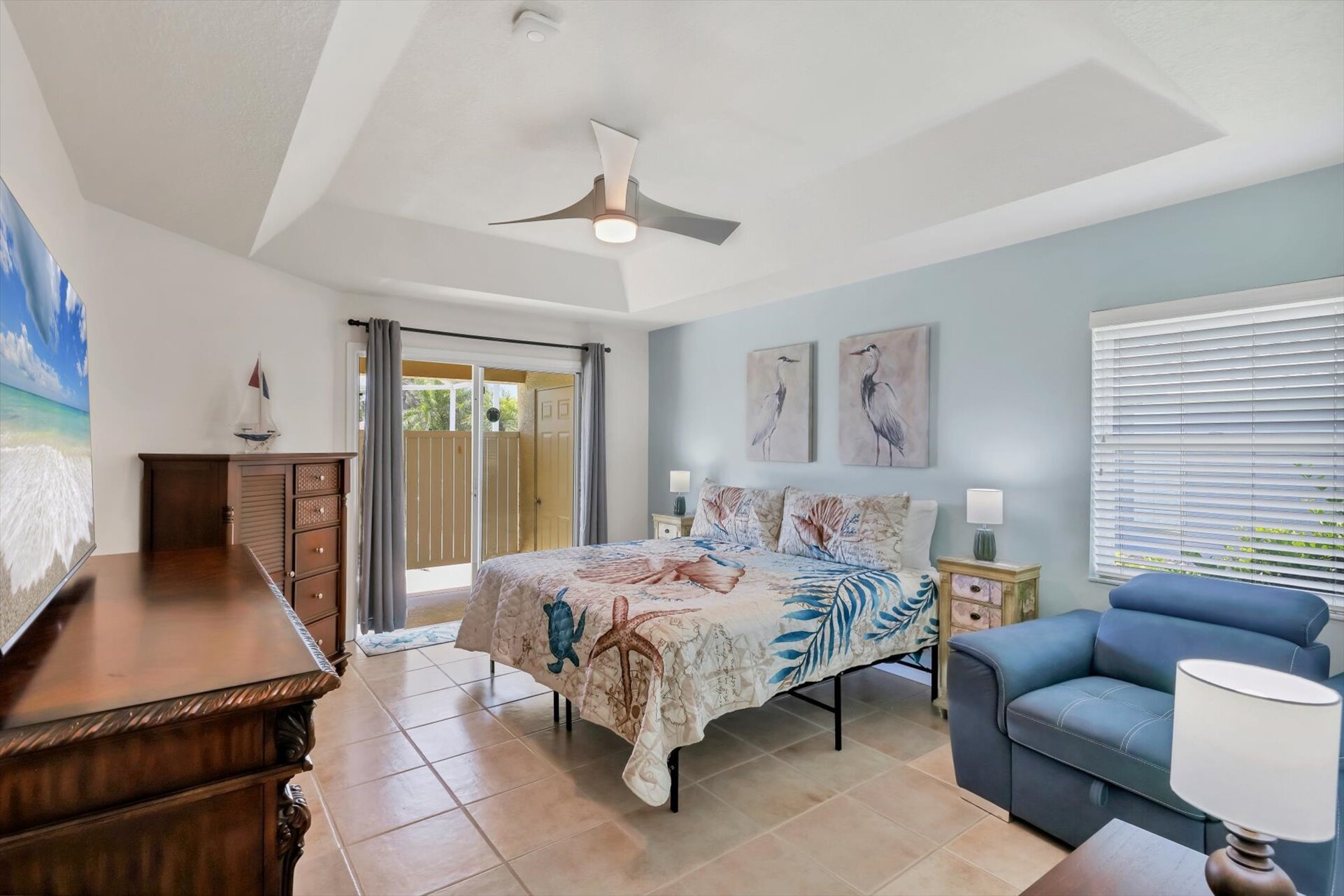 Primary bedroom with king bed, lanai access, ensuite, and 65" Smart TV