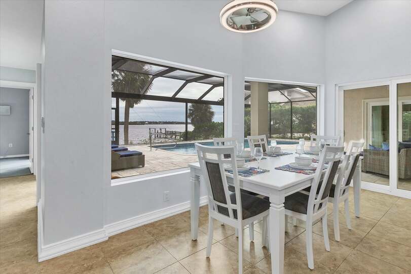 Dining area with water view. Dining table seats six, with additional seating for four at the kitchen island