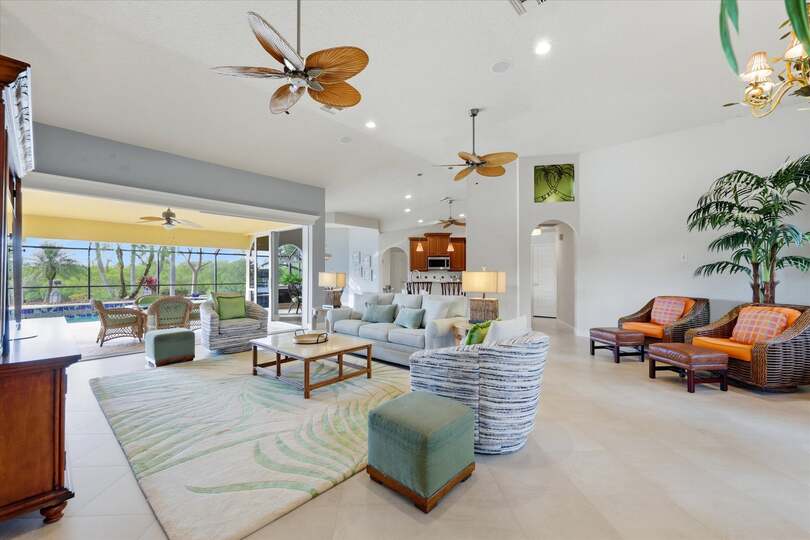 Large open living space overlooking the pool & canal beyond. Living room features lots of seating and 65-inch Smart TV