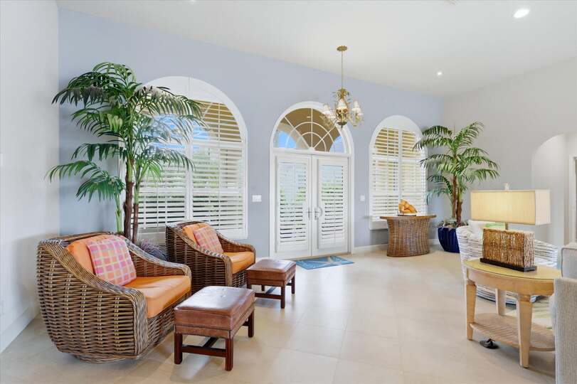Large open living space overlooking the pool & canal beyond. Living room features lots of seating and 65-inch Smart TV
