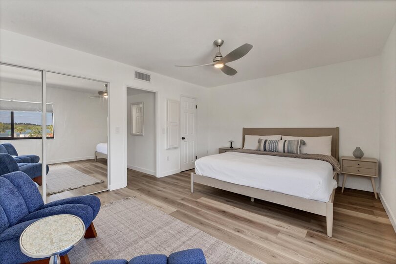 King bedroom with attached bathroom and view of bay