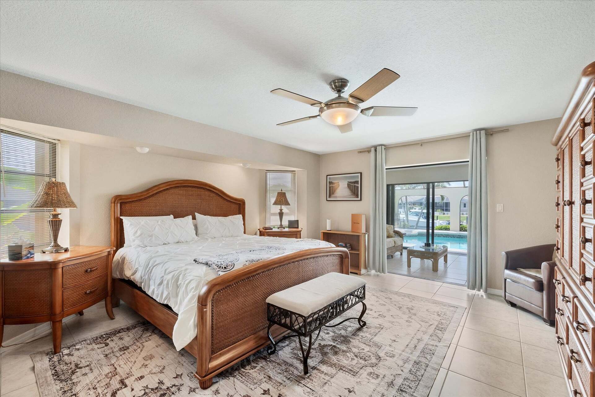 Primary Bedroom with King Bed, Attached Bathroom, Lanai Access, and 43" Smart TV